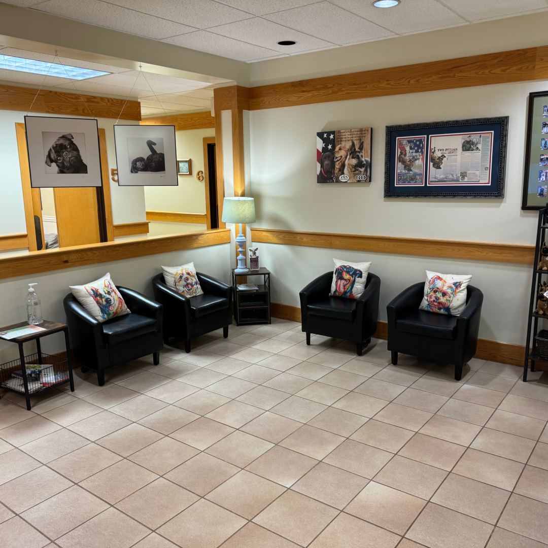 A waiting area with black chairs and a table